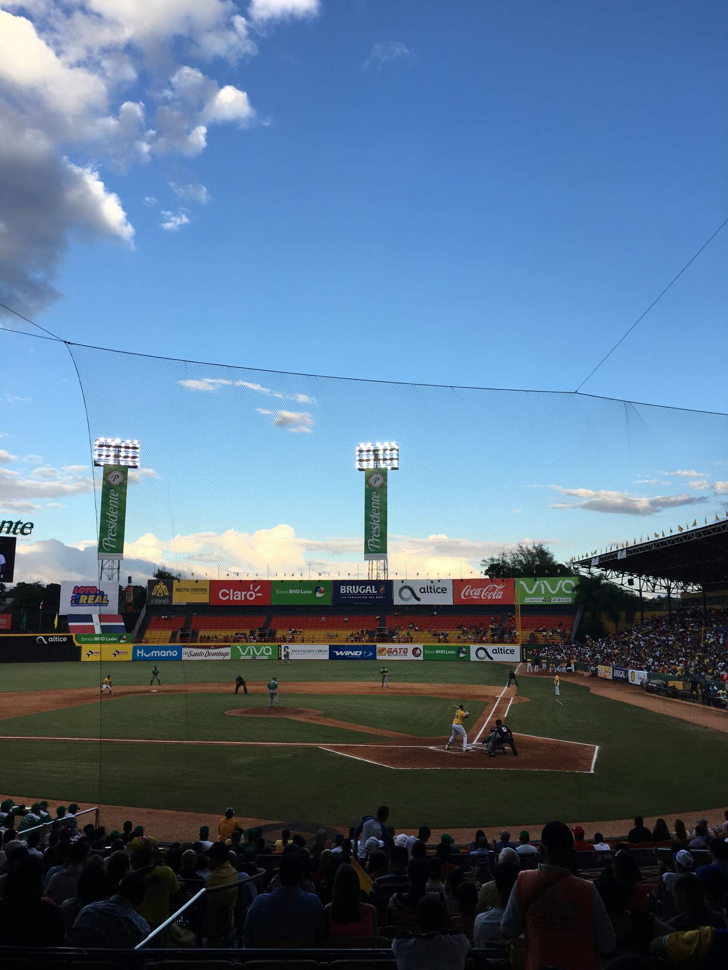 Watching a baseball game at the Cibao stadium, Santiago, Dominican Republic